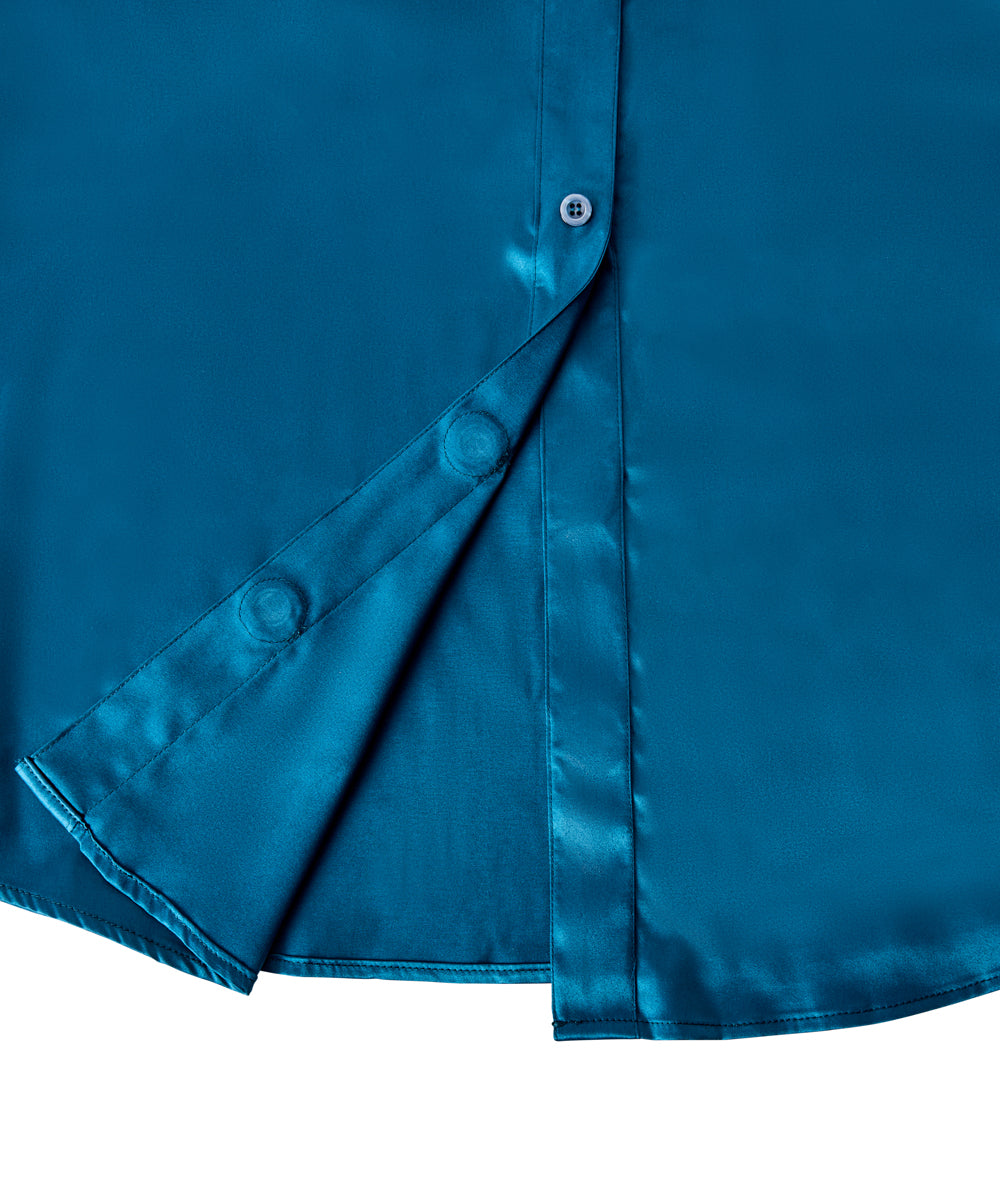 Close-up of a teal blue satin button-down shirt with a diagonal fold showing the smooth, shiny fabric texture and white buttons.