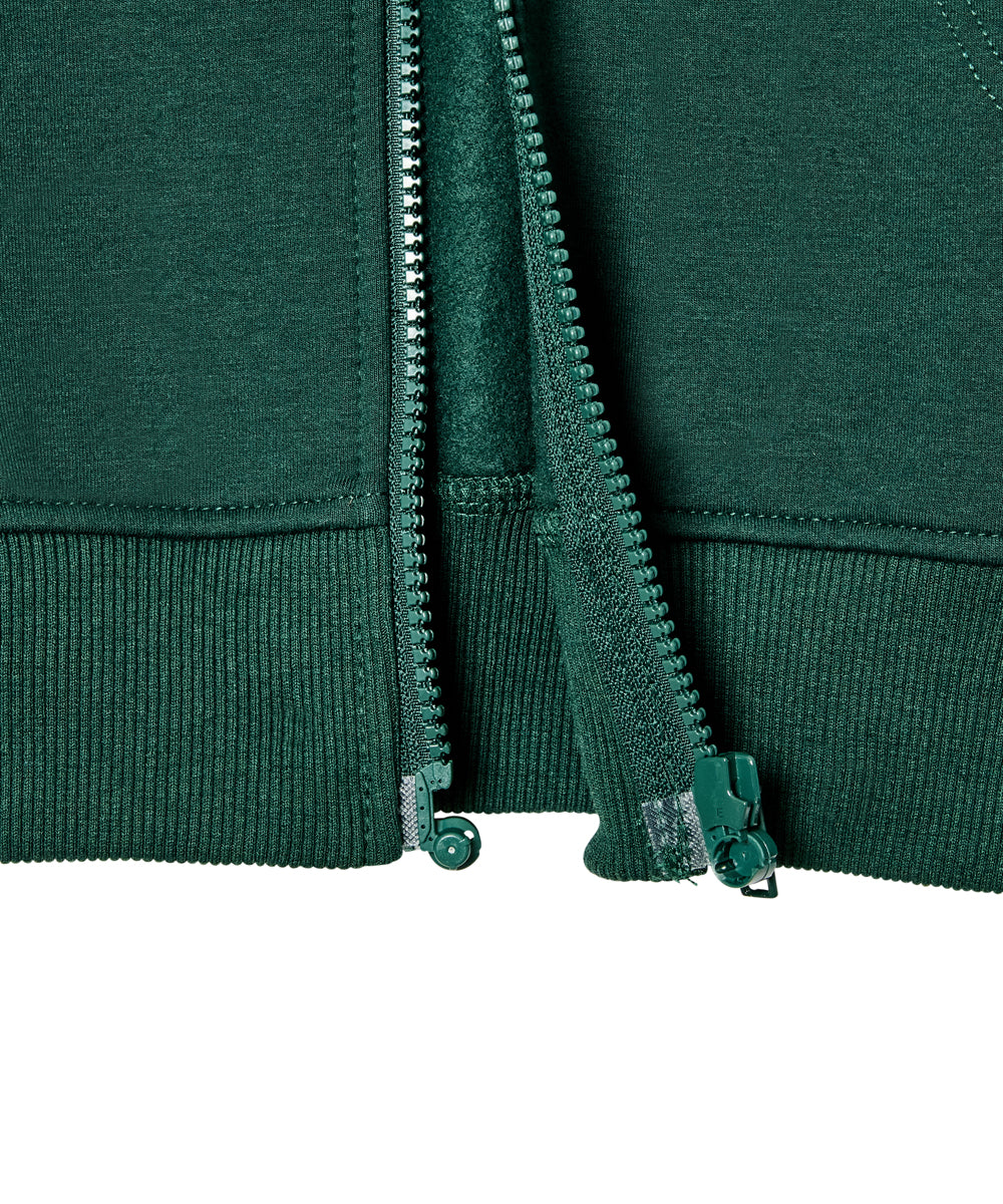 Close-up of a dark green zip-up hoodie showing the front zipper, ribbed hem, and matching green zipper pull tabs against a white background.